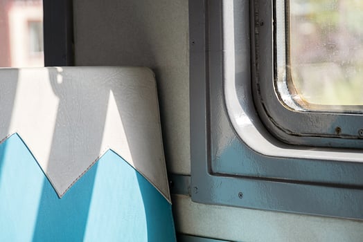 Sunlight streaming onto an empty train seat and window. photo