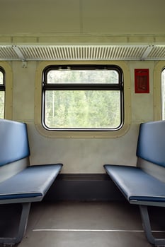 Empty old train compartment interior with blue seats. photo