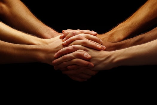 Hands of different people holding each other photo