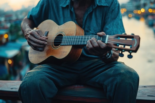 A man playing an acoustic guitar on a bridge photo