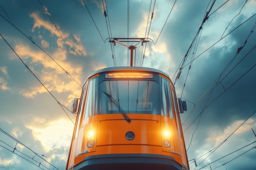 An orange train is traveling on the tracks photo