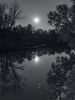 Moonlight Glow Reflecting on a Still Night Water Surface. photo