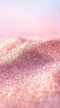 Soft rose gold glitter texture with blurred bright bokeh circles in a gentle gradient background. photo