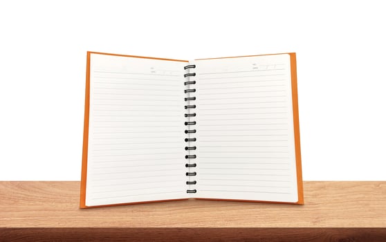 An open notebook is placed on a wooden table. photo