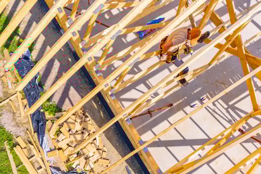 Construction Worker Assembling Wooden Frame at a Building Site photo
