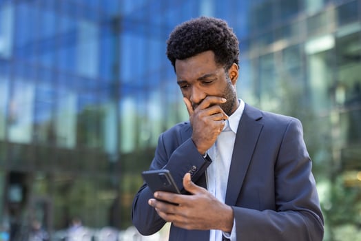 Man in suit using smartphone thoughtfully photo