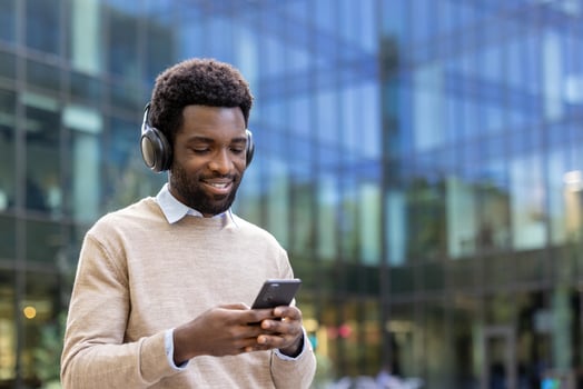man using smartphone with headphones photo