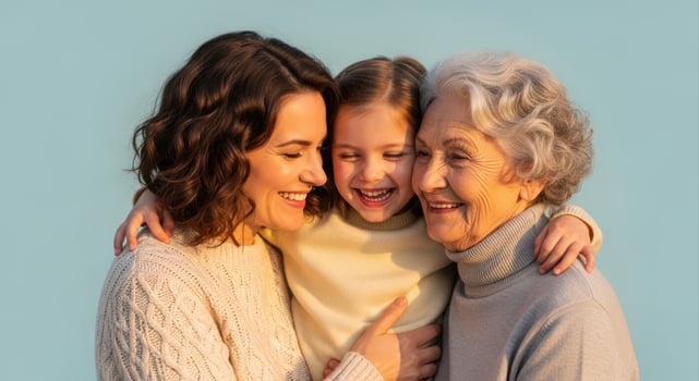 Three generations of happy women, a girl, mother, and grandmother, joyfully embracing photo