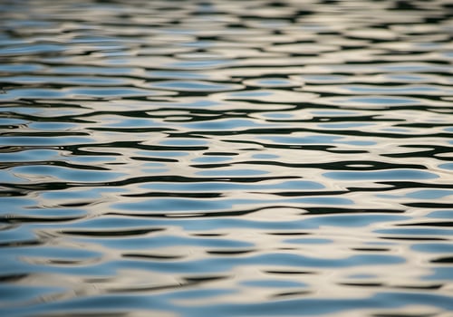 Water ripple reflections creating abstract patterns on surface with sunlight, high-resolution clean background without blur or human presence photo