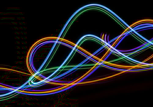 Long exposure colorful light trails forming abstract curves on a black background, high-resolution image with crisp edges and no human elements photo