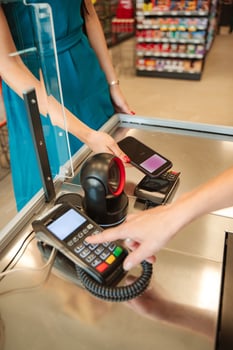 Customer paying with smartphone at supermarket checkout photo