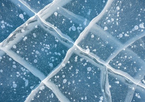 Detailed macro photo of frozen ice surface with visible cracks and bubbles, blue cold tone abstract background ideal for winter-themed or scientific design content