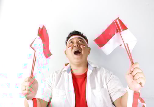 Cheerful Indonesian guy celebrating winning gesture photo