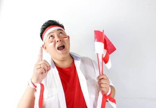 A man with a red and white flag and a white face photo