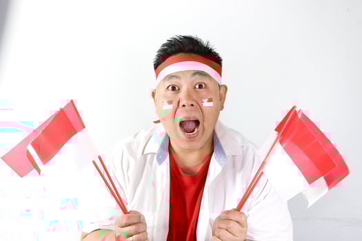 A man with a red bandana and two indonesian flags photo