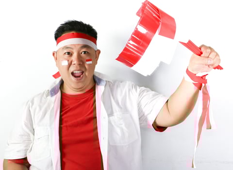 A man holding a red and white flag photo