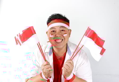 A man with a singapore flag on his head and two flags photo