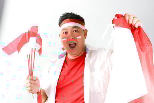 A man with a red and white flag and a white bandana photo