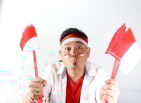 A man holding two red and white flags photo