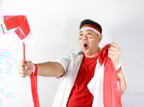 A man holding a flag and a fan photo
