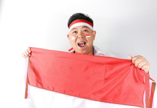A man holding an indonesian flag photo