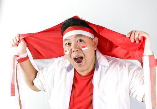 A man holding a flag over his head photo