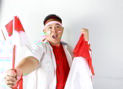 A man holding a flag and a face mask photo