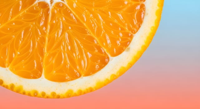 Macro close-up of orange slice with fine juice vesicle texture on pastel blue to coral gradient background, ultra detailed, crisp edges, noise free, natural lighting, no blur photo