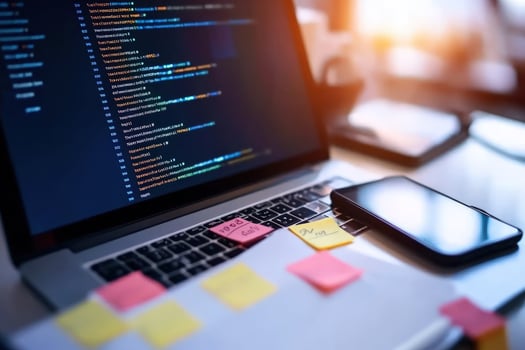 Coding Workspace Laptop Smartphone and Sticky Notes photo