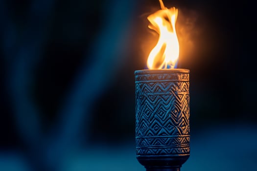 Ornate torch burning brightly at night outdoor setting photo