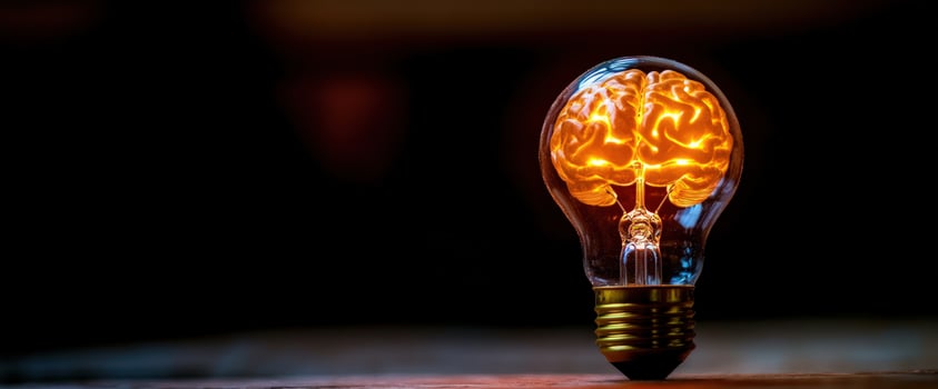 Glowing brain in bulb dark background idea concept photo
