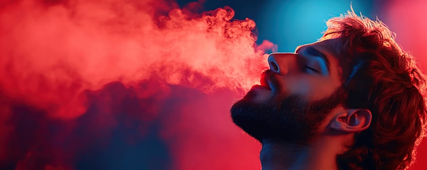 Man exhales vapor red-blue backdrop club scene ad use photo
