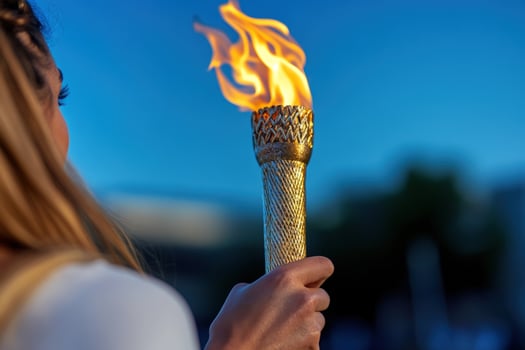 Woman holds flaming torch outdoor event twilight photo