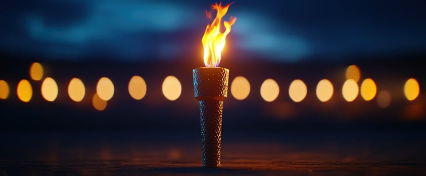 Burning torch night landscape lights blurred background event symbol photo