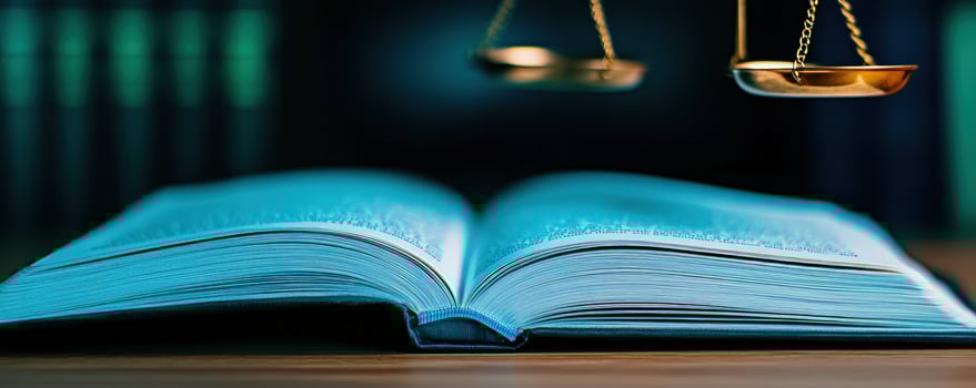 Open law book scales of justice library background photo