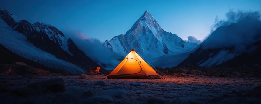 Illuminated tent at mountain base camp scenic twilight photo