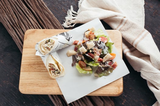 Wrap and salad on wooden board photo