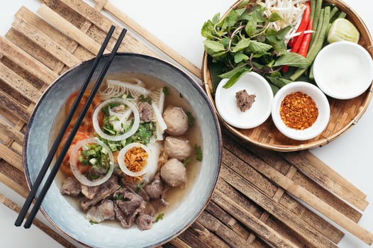 Vietnamese pho with fresh herbs and meat photo