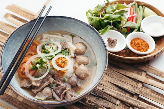 Vietnamese soup with herbs and meats photo