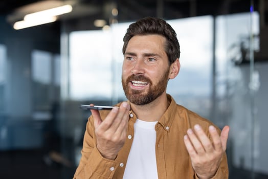 Man speaking on smartphone in office photo