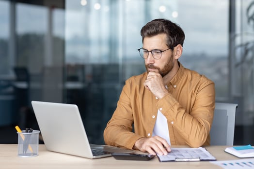 Man working on laptop in office photo