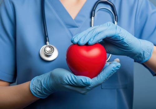 Medical professional holds red heart symbolizing health and care photo