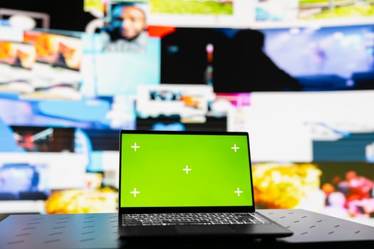 Laptop showcasing display with green screen mockup next to modern web design social network platforms, visual representation of trends and mobile interaction. Empty space for user experience. photo
