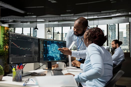 Team of traders in office using deep learning models to enhance predictive accuracy of stock market movements. African american prop firm coworkers leveraging AI to optimize trading strategies photo