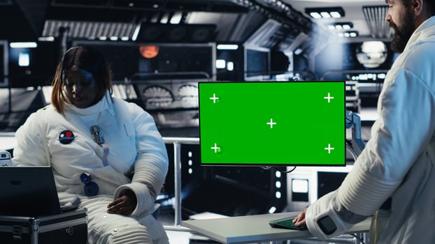 Researchers flying together in starship, looking at green screen monitor, exploring Mars. Cosmonauts using mockup display to ensure operational readiness before landing on red planet photo