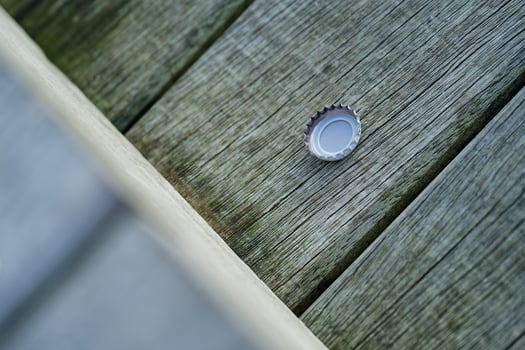 Old Wooden Planks with White Beer Bottle Cap photo