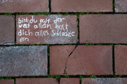 Chalk message on pink pavement with grass in between photo