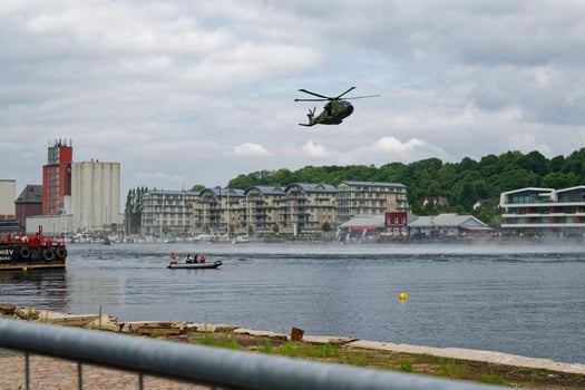 Rescue boat and military helicopter over sea during port demonstration in flensburg at Blaulichttag Bluelight day photo