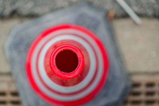 Close Up of a Red Traffic Cone with Reflective Stripes photo