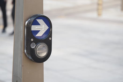 Pedestrian crossing signal with blue arrow direction photo